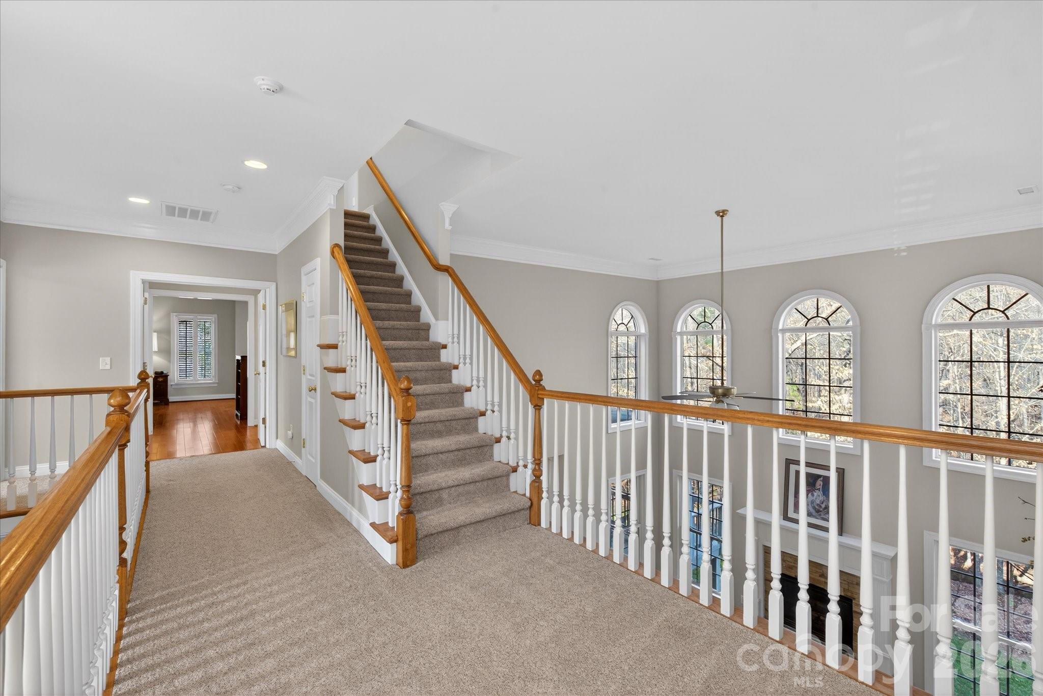 1237 Waynewood Drive Waxhaw, NC 28173 - Photo 25 of 32 a view of staircase with lots of frames on wall and windows