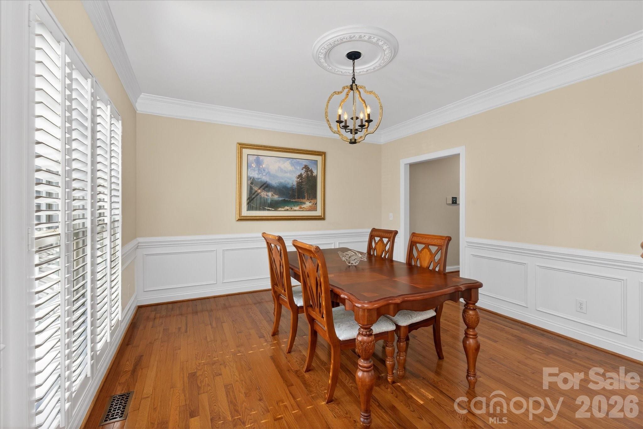 1237 Waynewood Drive Waxhaw, NC 28173 - Photo 4 of 32 a view of a dining room with furniture wooden floor and a chandelier