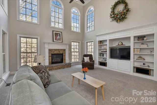 a living room with furniture a flat screen tv and a fireplace