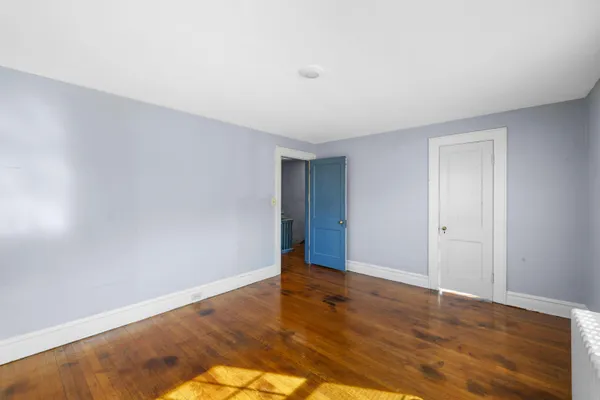 a view of room with window and hardwood floor