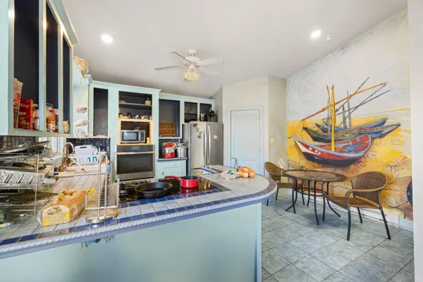 a kitchen with stainless steel appliances granite countertop a sink and cabinets