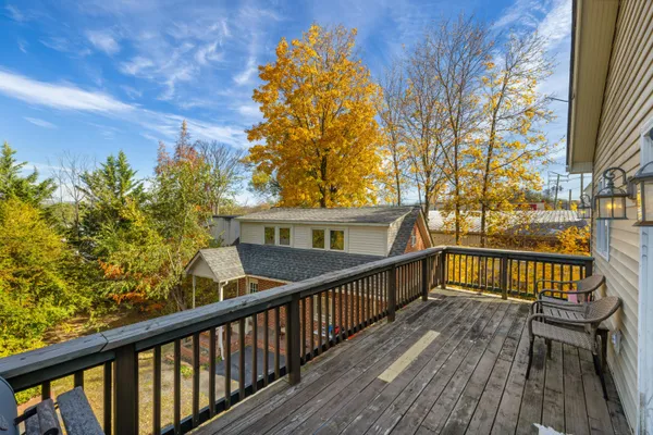 a view of a big house with wooden fence