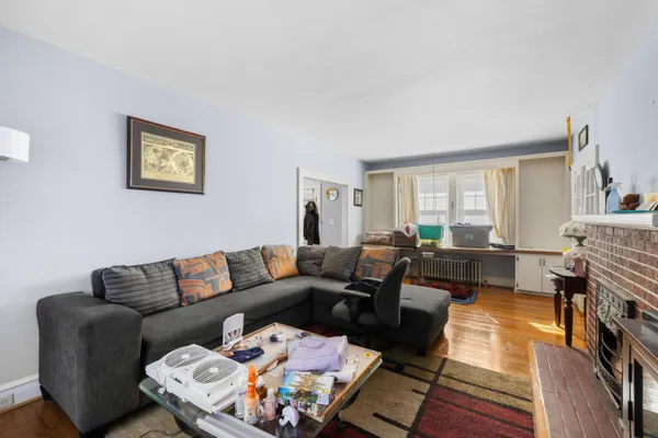 a dining room with furniture and wooden floor