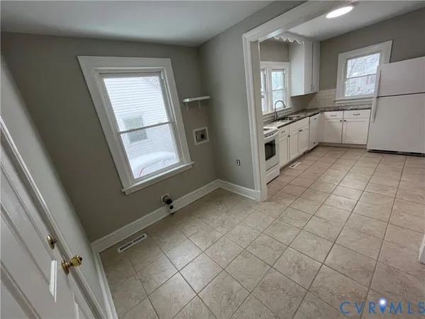 a kitchen with cabinets and window