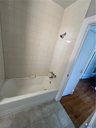 a bathroom with a toilet a sink a mirror and a window