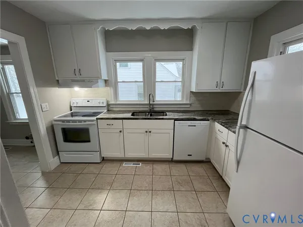 a kitchen with a stove sink and a refrigerator