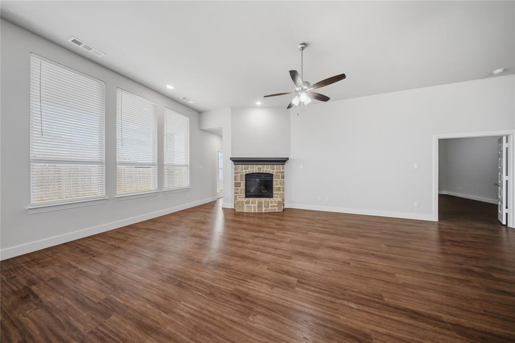 1665 Sheldon Drive Forney, TX 75126 - Photo 11 of 35 a view of an empty room with wooden floor fireplace and a window