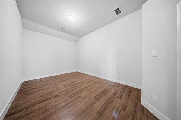 a view of room with wooden floor