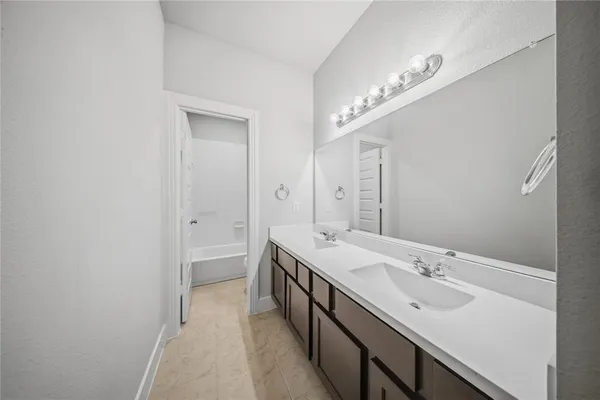 a bathroom with a double vanity sink a and a mirror