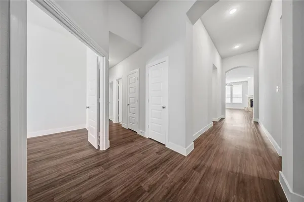a view of a hallway with wooden floor