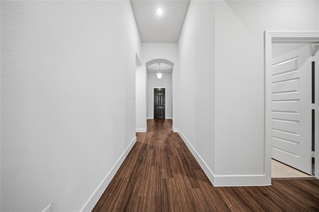 1665 Sheldon Drive Forney, TX 75126 - Photo 28 of 35 a view of a hallway with wooden floor