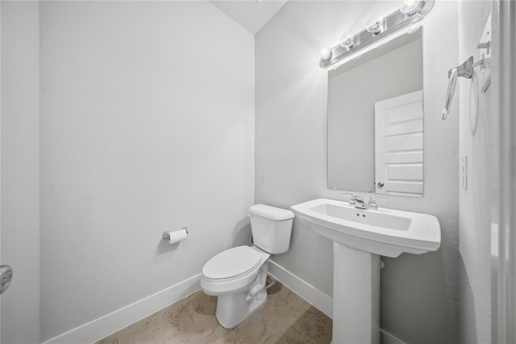 1665 Sheldon Drive Forney, TX 75126 - Photo 29 of 35 a bathroom with a sink toilet and mirror