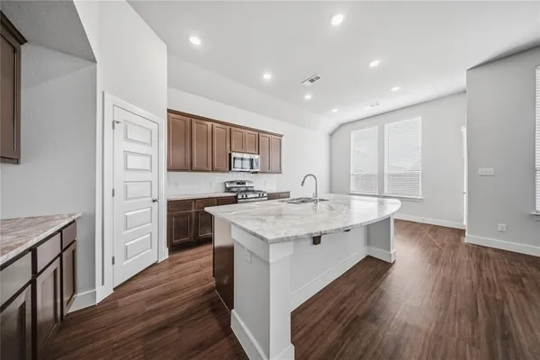 a kitchen with a sink stove and cabinets