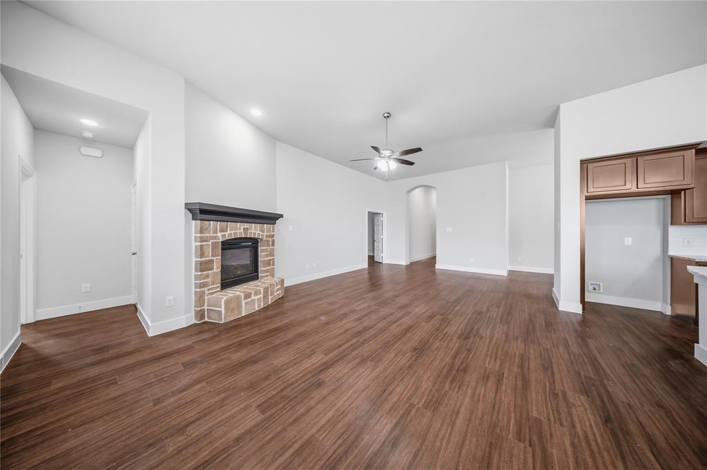 1665 Sheldon Drive Forney, TX 75126 - Photo 7 of 35 a view of empty room with wooden floor and fireplace