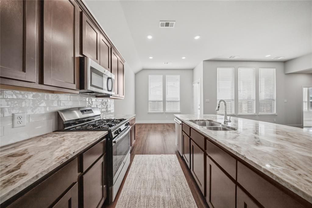 1665 Sheldon Drive Forney, TX 75126 - Photo 8 of 35 a kitchen with granite countertop lots of counter space and a sink