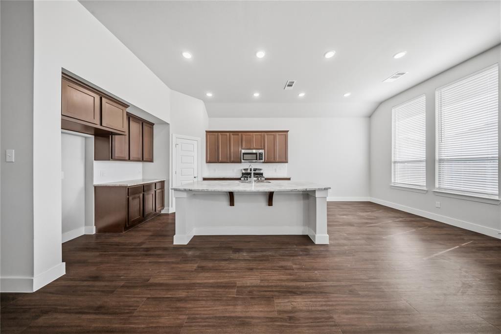 1665 Sheldon Drive Forney, TX 75126 - Photo 9 of 35 a view of kitchen with microwave refrigerator and cabinets