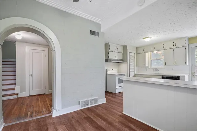 a view of a kitchen with wooden floor
