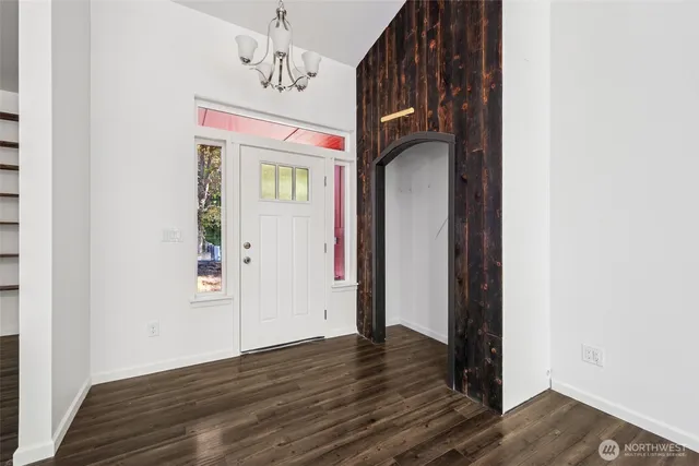 a view of hallway with wooden floor