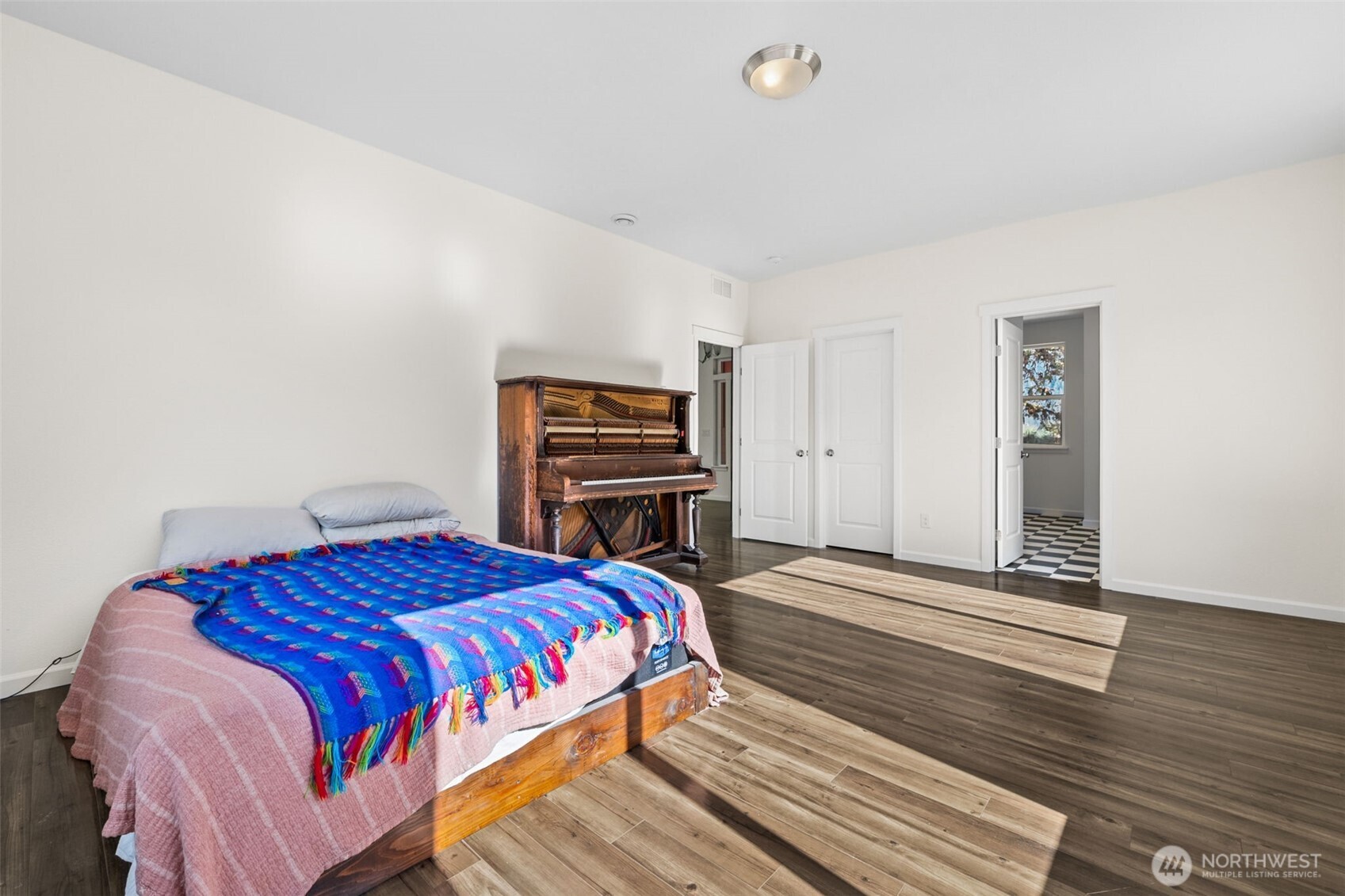 662 Cline Road Randle, WA 98377 - Photo 15 of 36 a bedroom with a bed and wooden floor