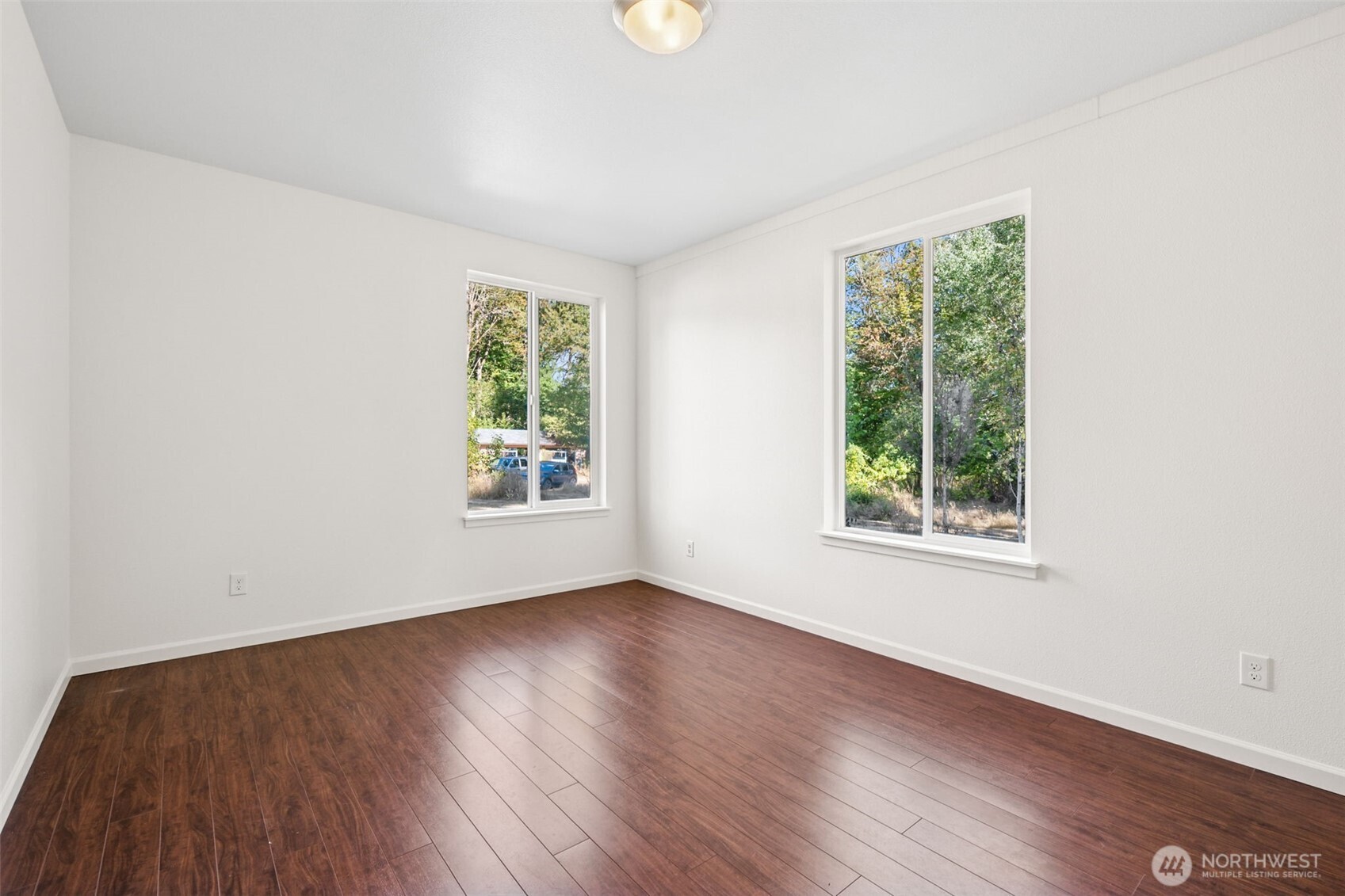 662 Cline Road Randle, WA 98377 - Photo 16 of 36 an empty room with wooden floor and windows