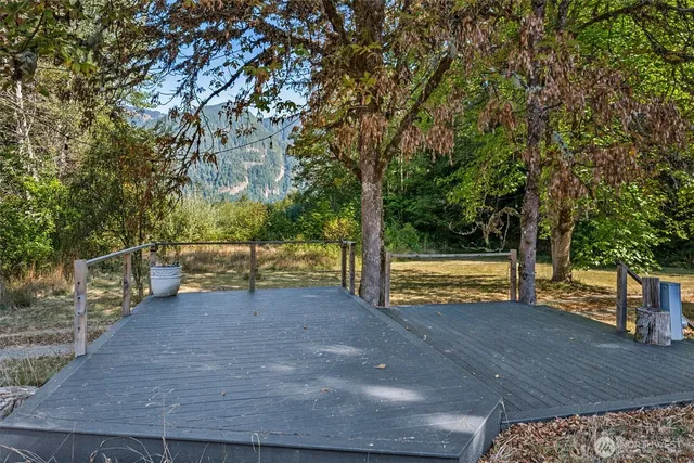 a view of a yard with wooden fence
