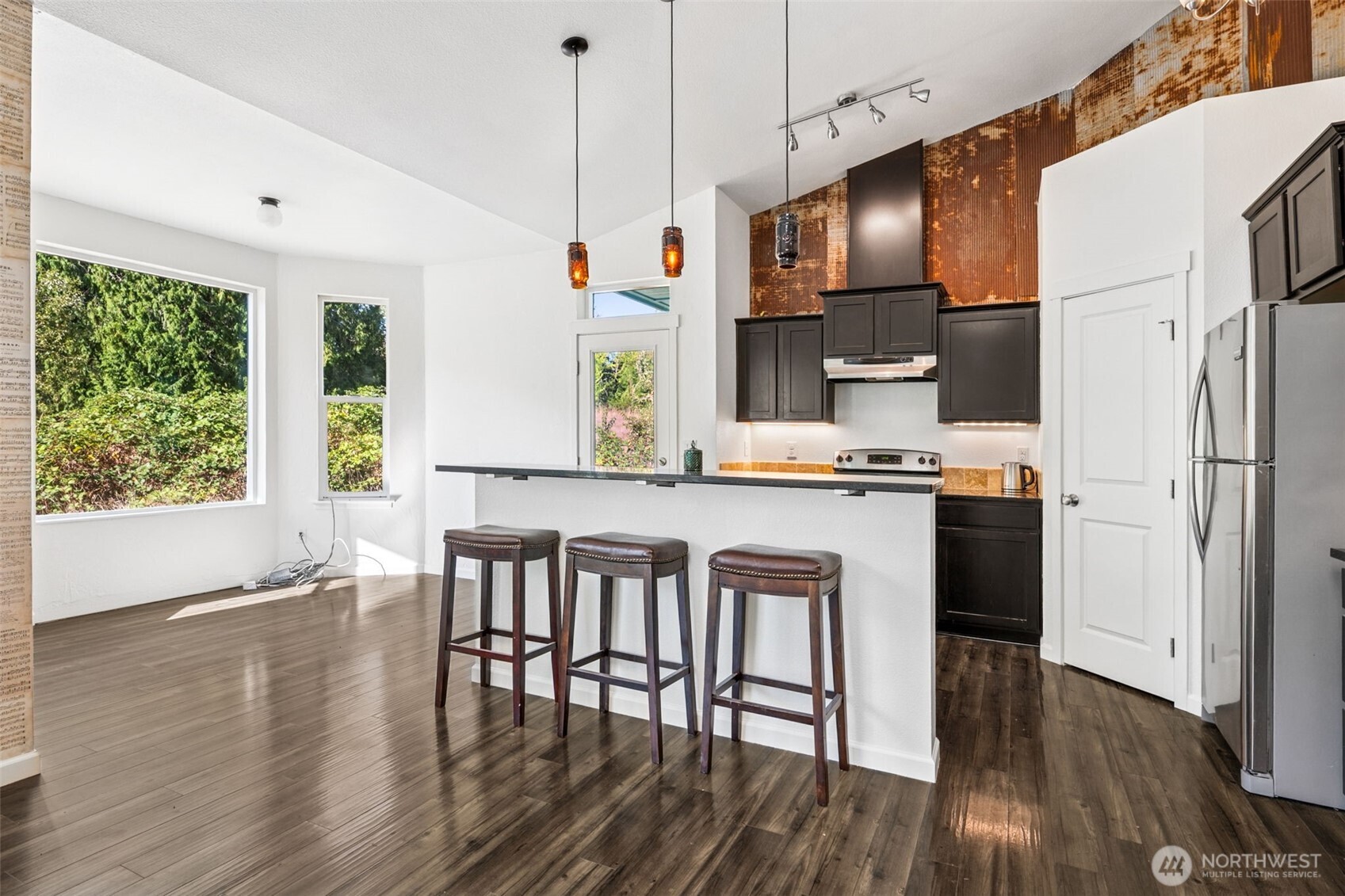 662 Cline Road Randle, WA 98377 - Photo 4 of 36 a kitchen with stainless steel appliances a dining table chairs refrigerator and sink