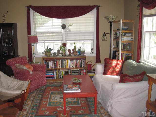 2135 Milburnie Road Raleigh, NC 27610 - Photo 3 of 17 a living room with furniture a large window and a dining table