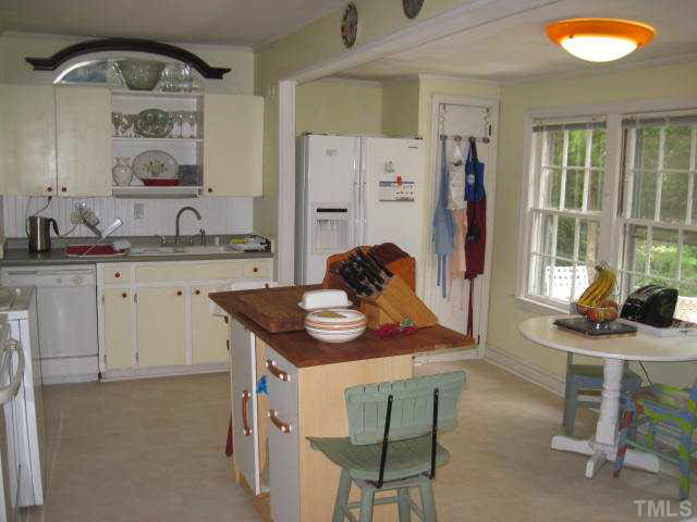 2135 Milburnie Road Raleigh, NC 27610 - Photo 6 of 17 a view of kitchen island with furniture and wooden floor