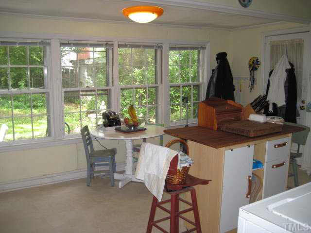 2135 Milburnie Road Raleigh, NC 27610 - Photo 8 of 17 a kitchen with a stove a sink and a refrigerator