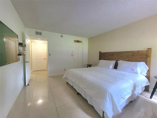 a bedroom with a bed and a lamp