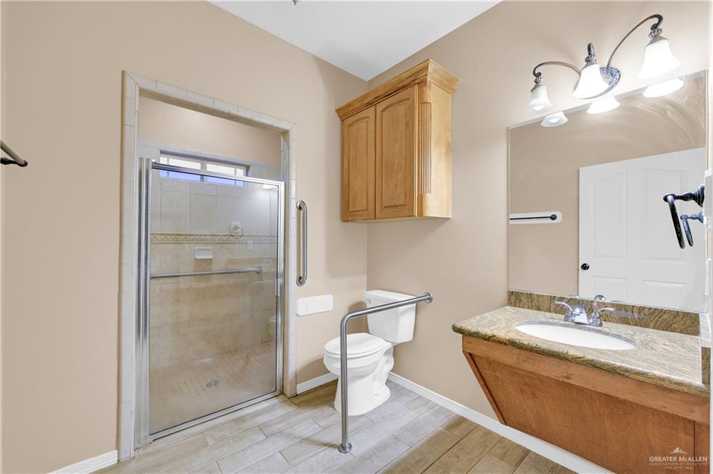 2005 Stuart Road Weslaco, TX 78599 - Photo 20 of 30 a bathroom with a sink a toilet and shower