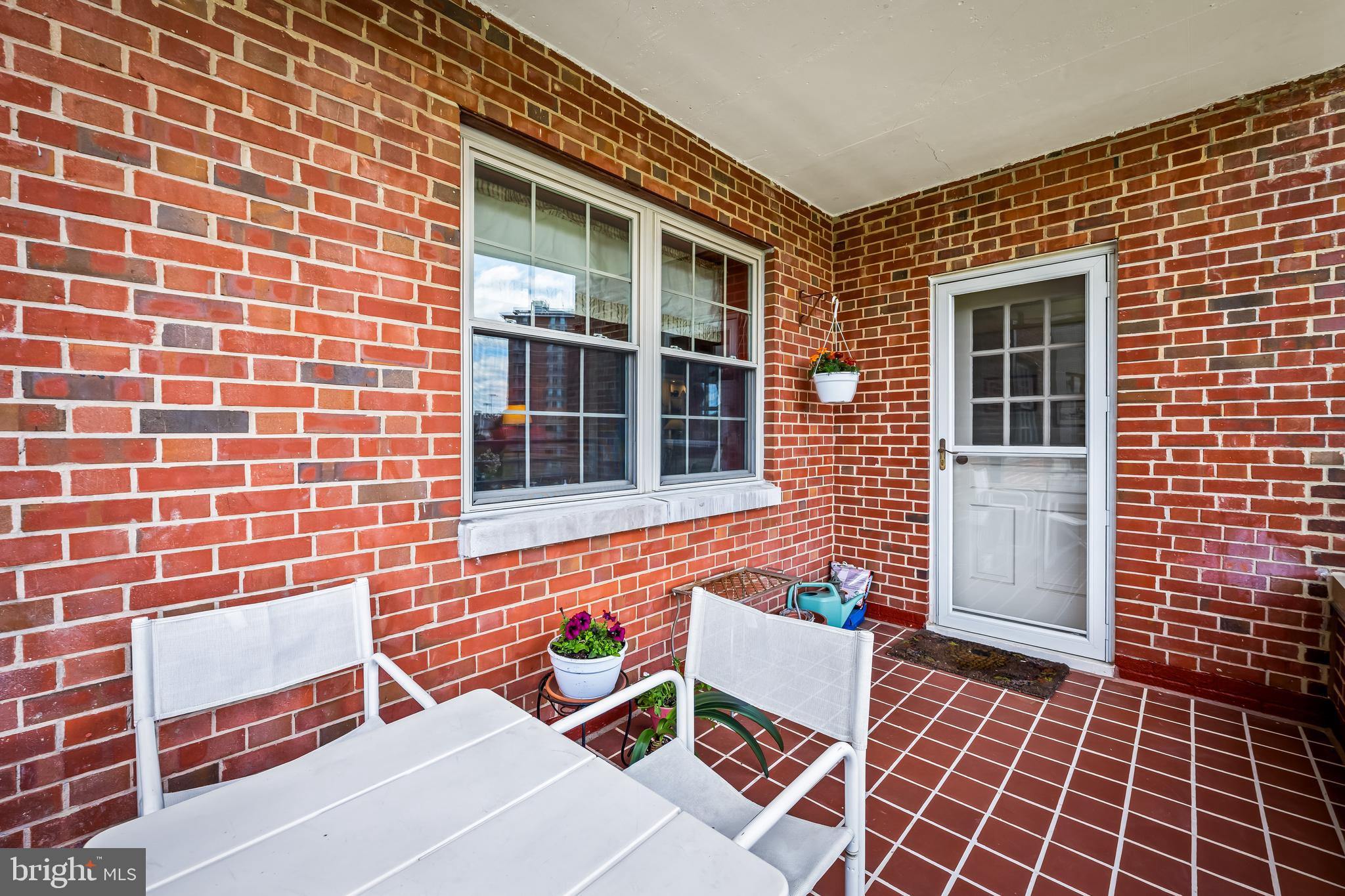 3601 Greenway, Unit 705 Baltimore, MD 21218 - Photo 24 of 30 a brick building with a bench in front of door