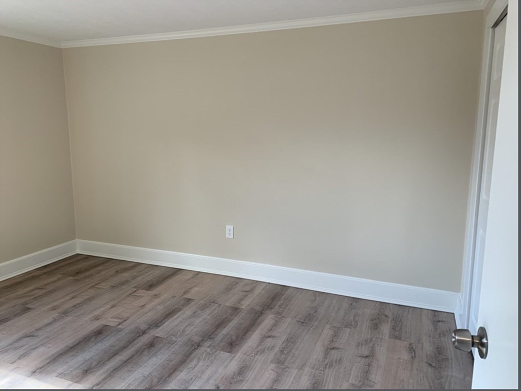 10 Mill Street, Unit X Maynard, MA 01754 - Photo 12 of 17 a view of an empty room with wooden floor