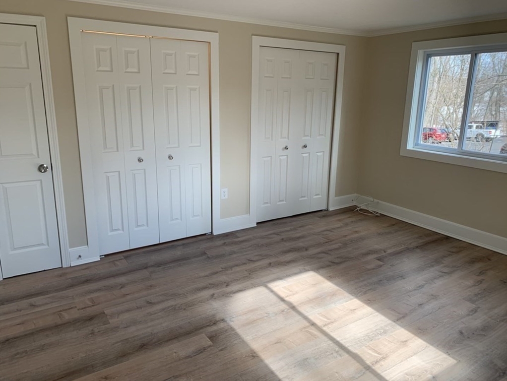 10 Mill Street, Unit X Maynard, MA 01754 - Photo 14 of 17 a view of empty room with wooden floor and fan