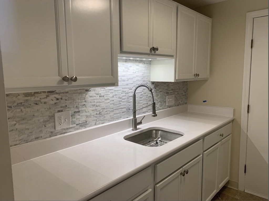 10 Mill Street, Unit X Maynard, MA 01754 - Photo 2 of 17 a kitchen with a sink and cabinets