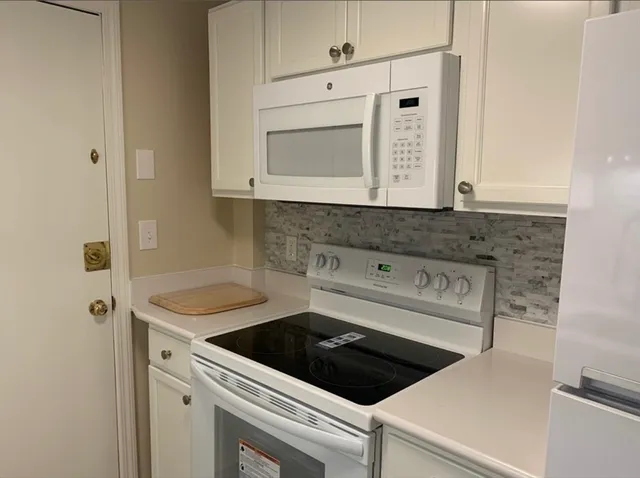 a kitchen with a sink and a refrigerator