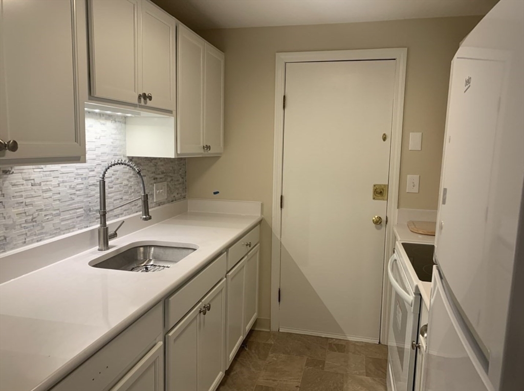 10 Mill Street, Unit X Maynard, MA 01754 - Photo 4 of 17 a kitchen with a sink and a refrigerator