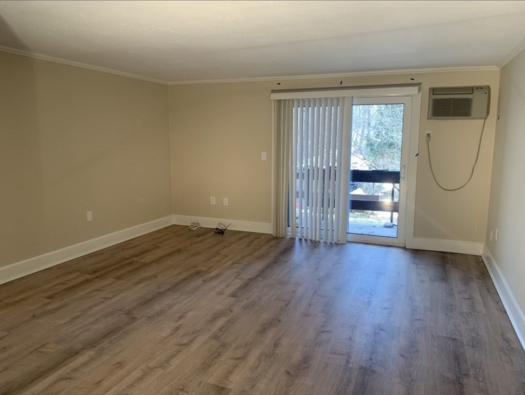 10 Mill Street, Unit X Maynard, MA 01754 - Photo 6 of 17 an empty room with wooden floor and windows