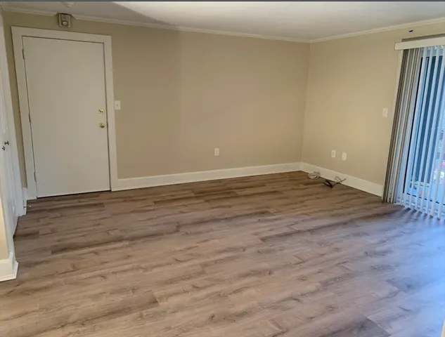 a view of a room with wooden floor
