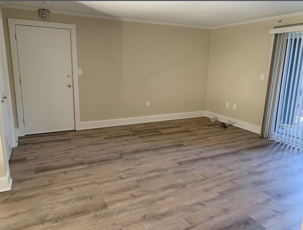 10 Mill Street, Unit X Maynard, MA 01754 - Photo 7 of 17 a view of an empty room with wooden floor and a window