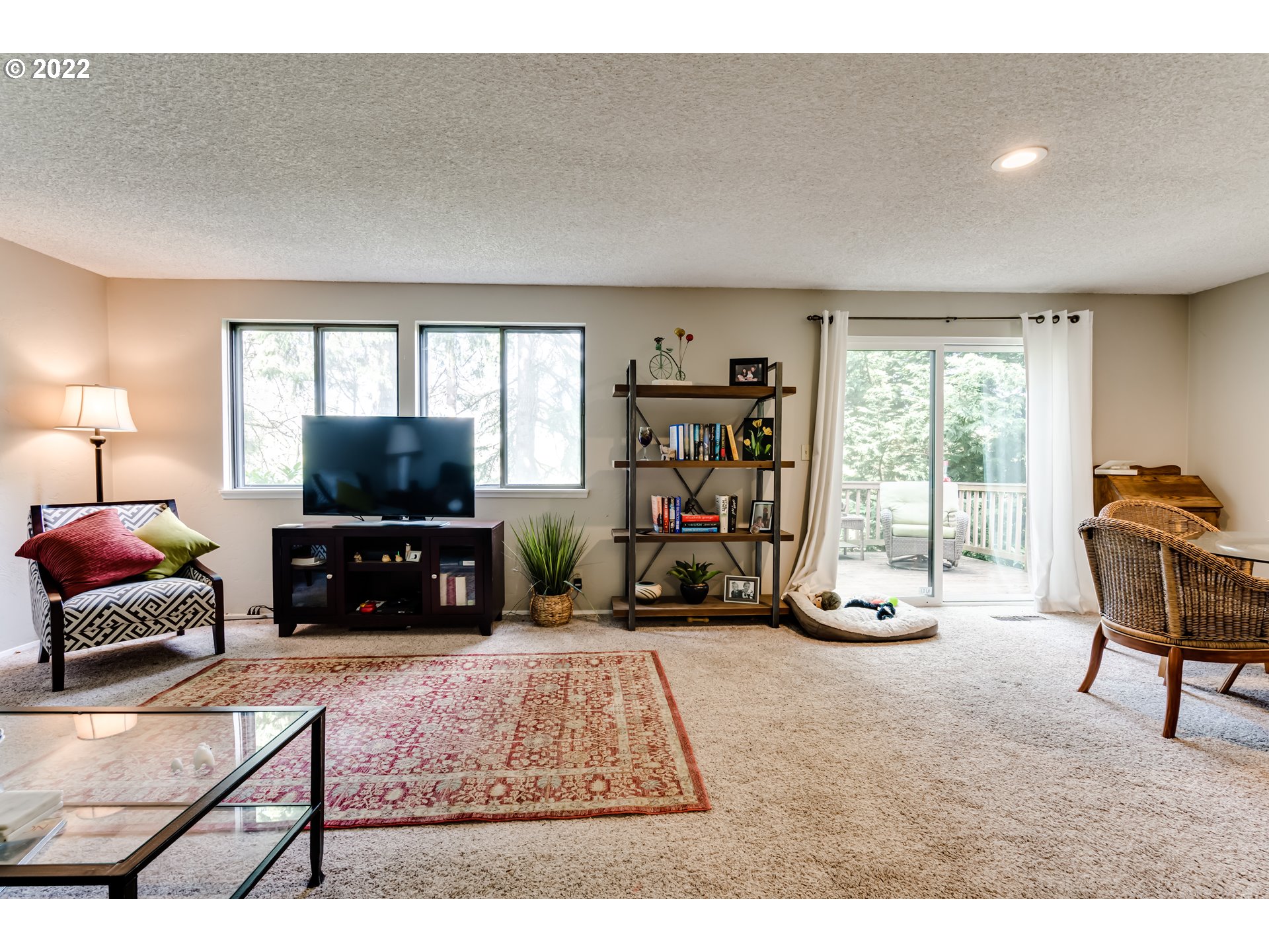 2220 Ridgeway Drive Eugene, OR 97401 - Photo 7 of 32 a living room with furniture a flat screen tv and a large window