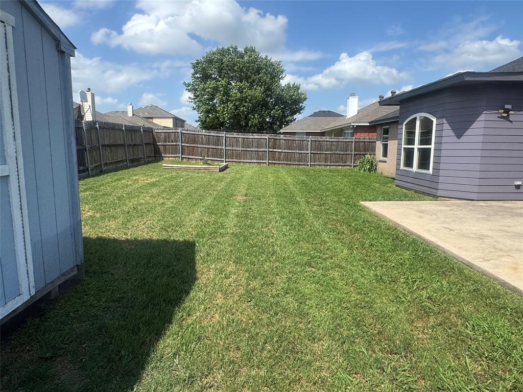 908 Cedar Ridge Lane Burleson, TX 76028 - Photo 22 of 24 a view of a backyard with a garden