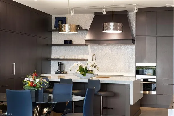 a kitchen with a dining table and chairs