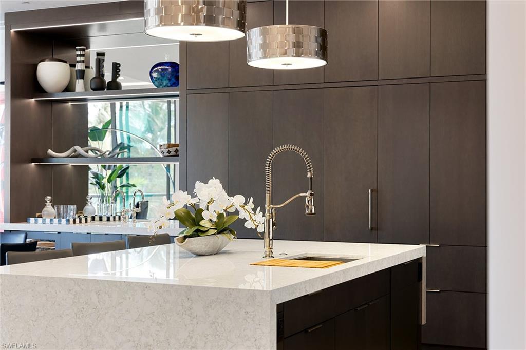 495 5th Street South, Unit 304 Naples, FL 34102 - Photo 15 of 33 a room with a table and chairs