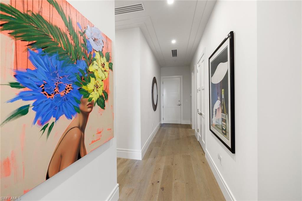 495 5th Street South, Unit 304 Naples, FL 34102 - Photo 18 of 33 a view of a hallway with wooden floor