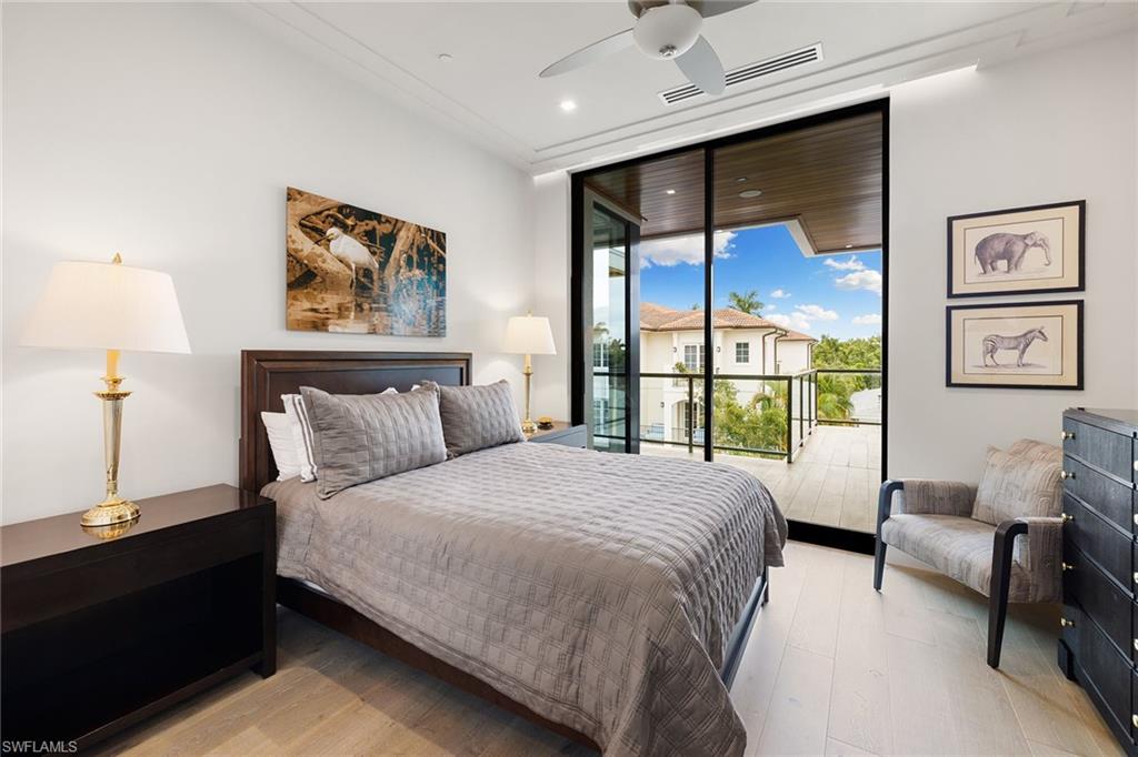 495 5th Street South, Unit 304 Naples, FL 34102 - Photo 25 of 33 a bedroom with a large bed and a window