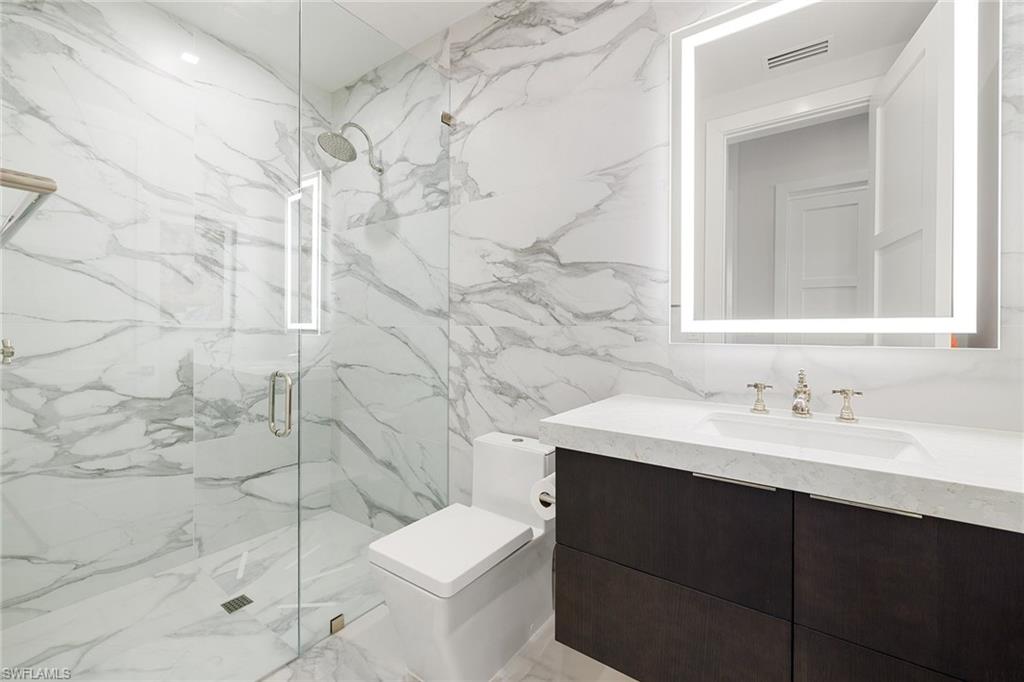 495 5th Street South, Unit 304 Naples, FL 34102 - Photo 26 of 33 a bathroom with a sink and mirror