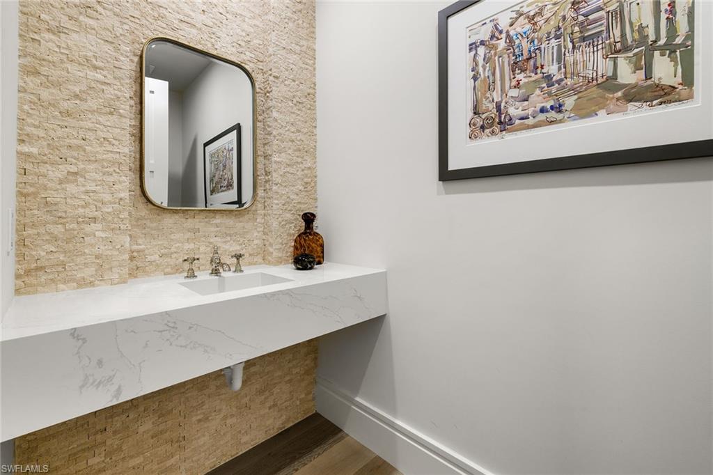 495 5th Street South, Unit 304 Naples, FL 34102 - Photo 28 of 33 a bathroom with a sink and a mirror