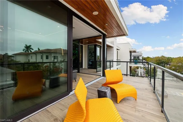 a view of a balcony with chairs