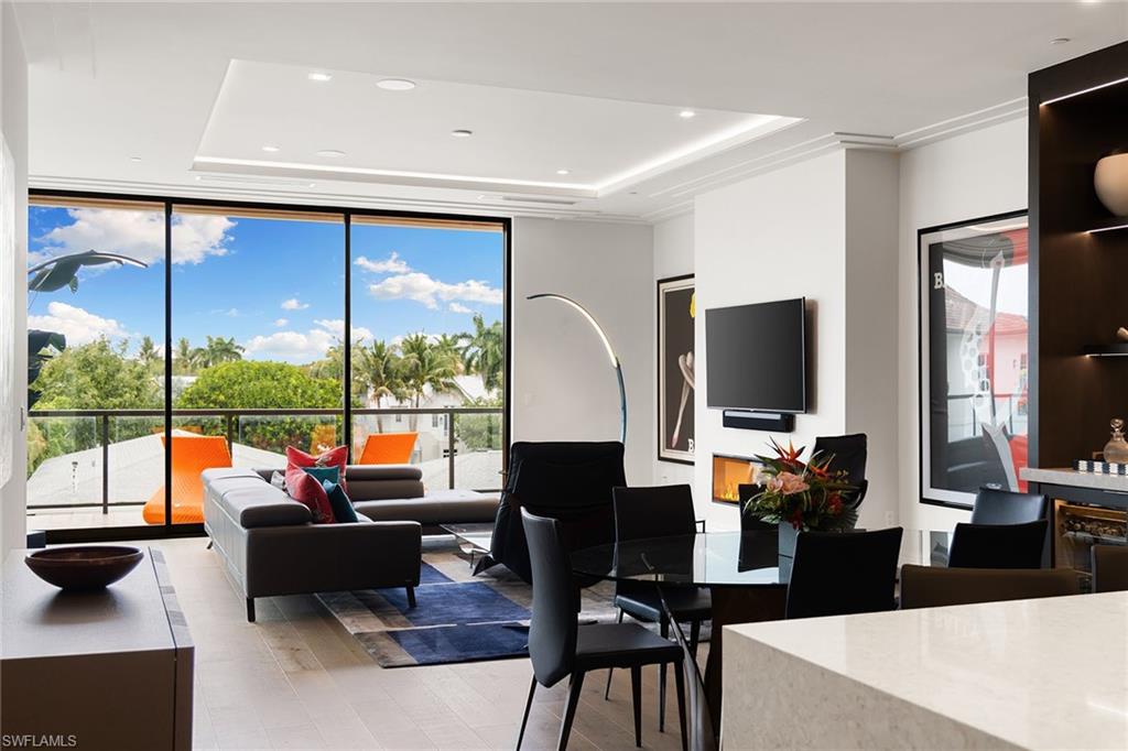 495 5th Street South, Unit 304 Naples, FL 34102 - Photo 5 of 33 a living room with fireplace furniture and a flat screen tv